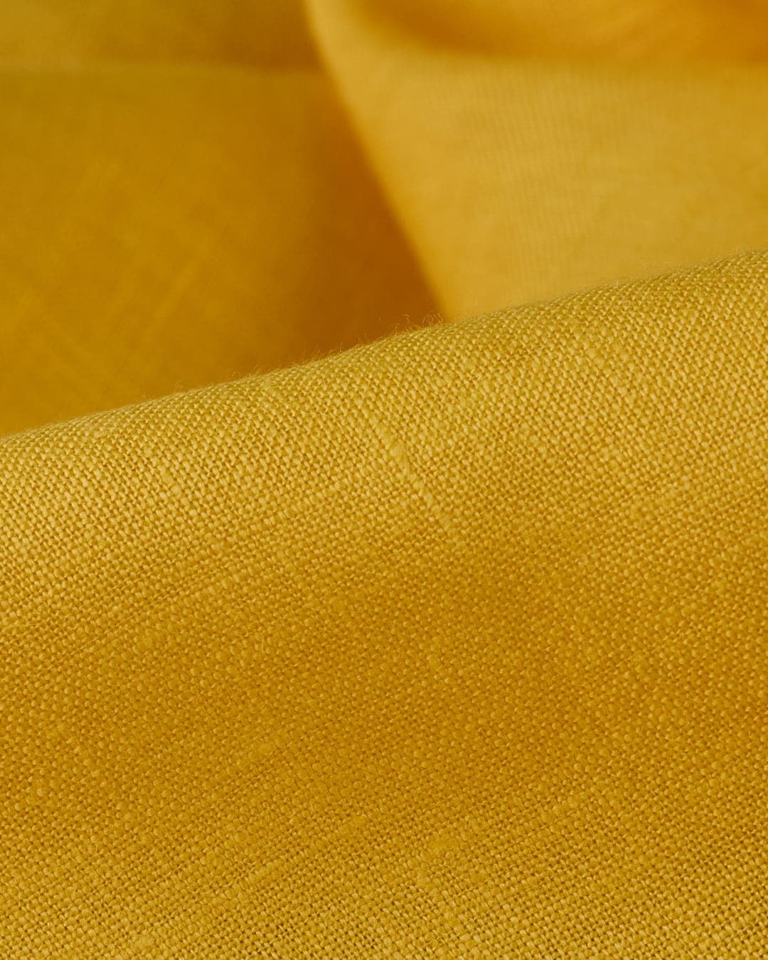 Mustard-yellow linen, draped in soft folds